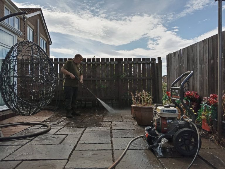 Pressure washing a back yard patio