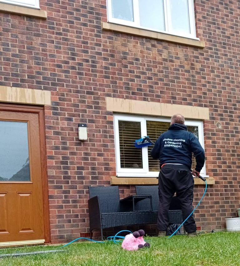 John cleaning a ground floor window with a water-fed pole