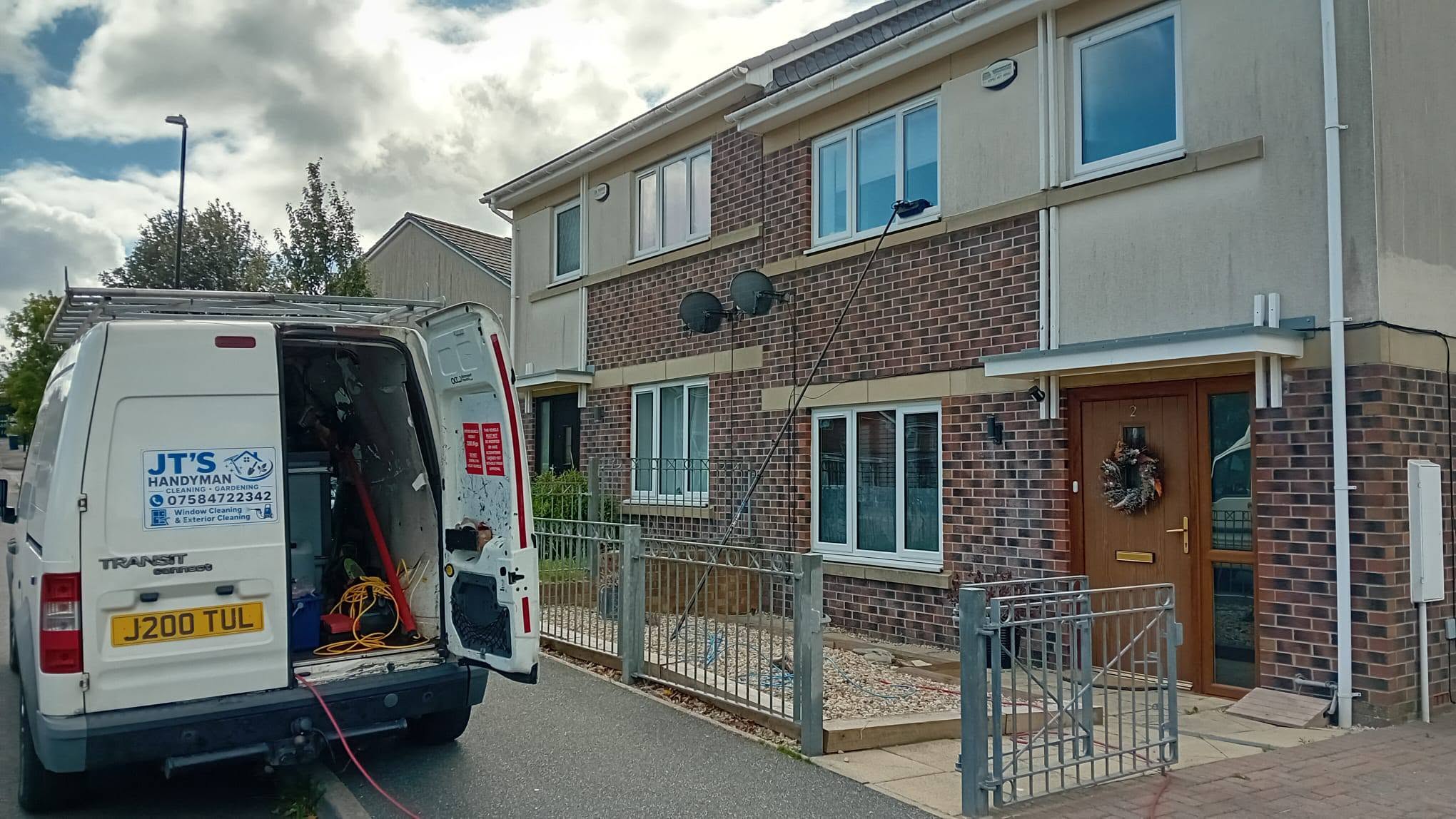 JT's Handyman van outside a house during a window clean